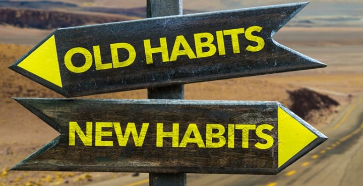 Image of a road sign, one way pointing to old habits, one way pointing to new habits