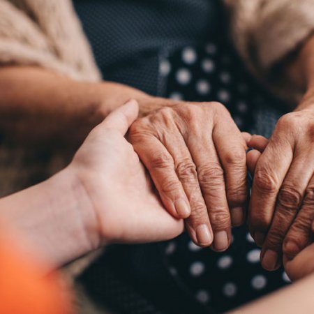 young hands hold older persons hands